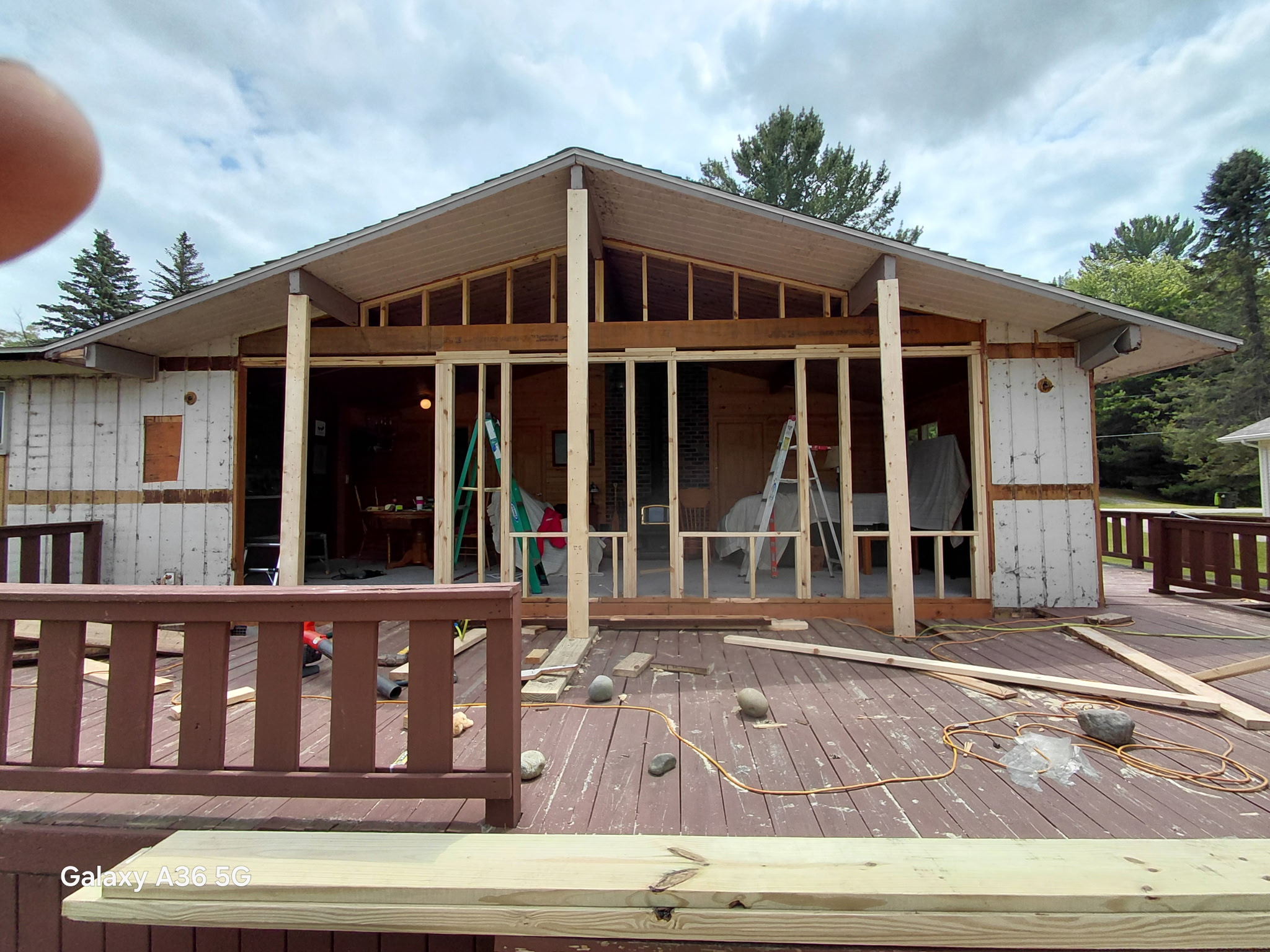 Mid-construction view of a cabin rebuild showing exposed framing and structural work