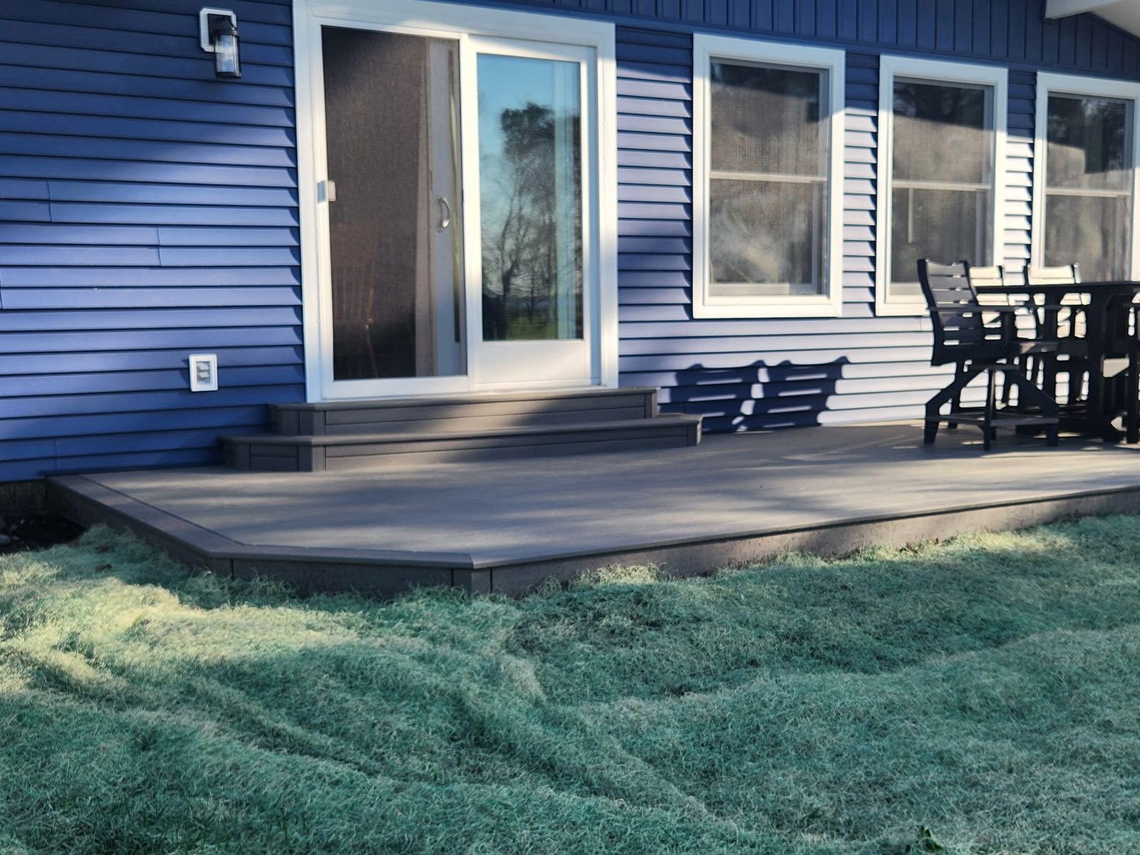 Finished cabin deck with patio furniture and fresh sod