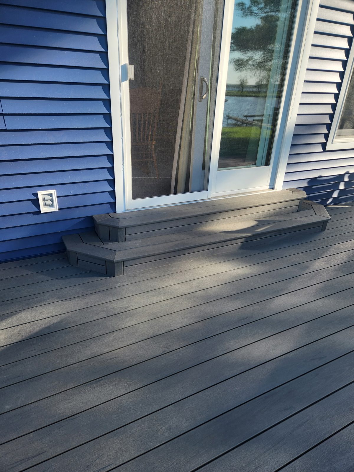 Close-up of the new composite decking and step up to the sliding door
