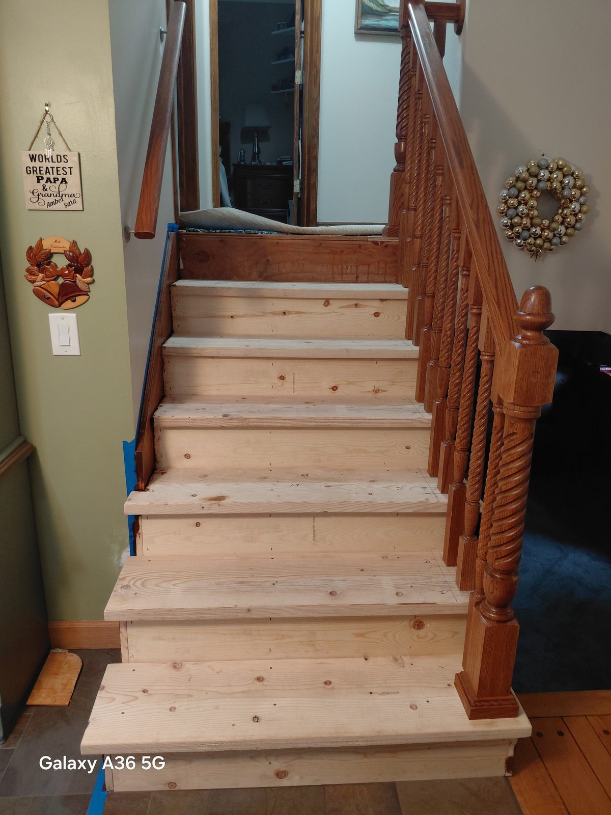 Newly built wood stairs prepped and handrail being stained