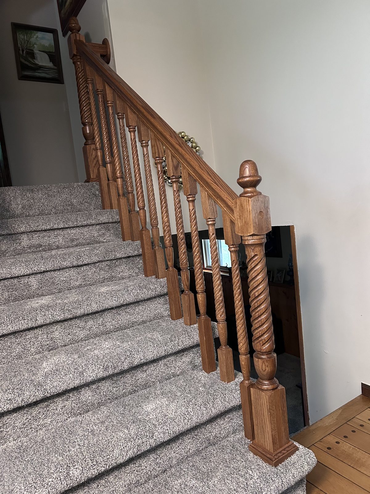 Detail of finished staircase with hand-turned balusters and newel post